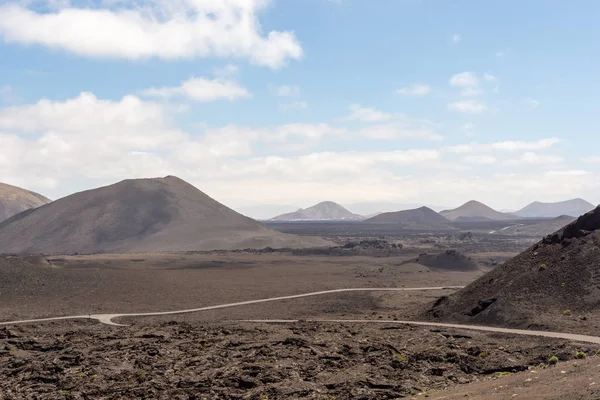 Roads in amazing volcanic landscape of Timanfaya national park, Lanzarote, Canary Islands, Spain