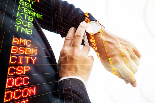 Double exposure Businessman looking at his watch in office — Stock Photo, Image