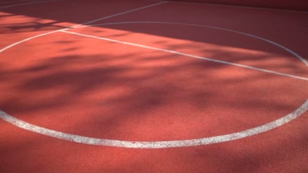 Streetball court with white lines on red background — Stock Video