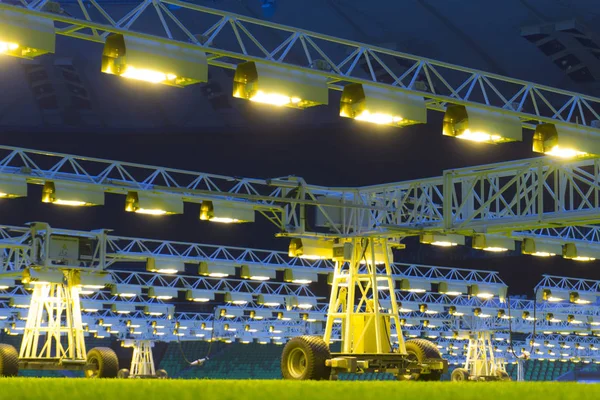 Mobile grow lighting system in sports stadium at night.