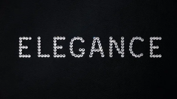 Word Elegance Made Shiny White Swarovski Crystals Placed Black Leather — Stock Photo, Image