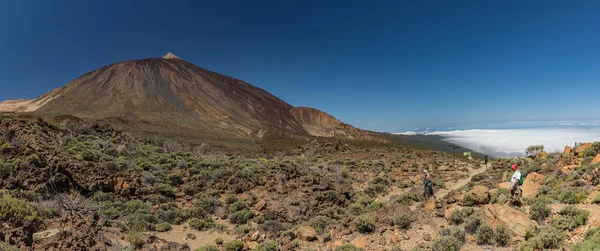 Mountain Teide med vita snö fläckar, delvis täckt av molnen. Klarblå himmel. Nationalparken Teide, Teneriffa, Kanarie öarna, Spanien. — Stockfoto