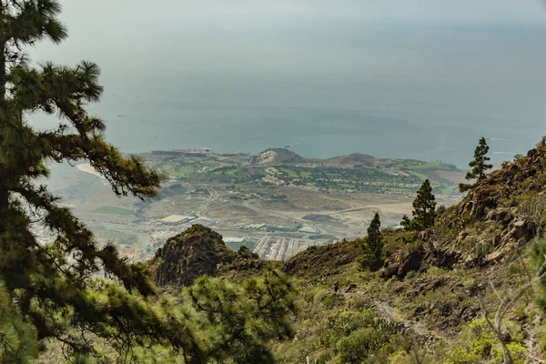 Güneşli bir günde batı kıyı şeridinin havadan görünümü. Mavi gökyüzü ve bulutlar. Kuru dağ bölgesinde kayalık izleme yolu. Tenerife, Kanarya Adası — Stok fotoğraf