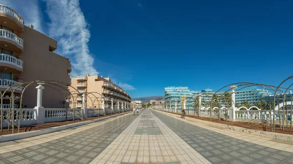 Amplia calle peatonal en el complejo turístico Playa de las Américas. Vista panorámica de gran angular. Día soleado claro con muy pocas nubes blancas hermosas. Isla de Tenerife, Islas Canarias, España — Foto de Stock