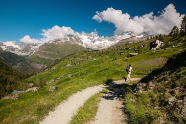 Dağ izi yürüyüş ve İsviçre Valais (Pennine) Alpleri'nde görkemli Matterhorn dağ manzarasına hayran sırt çantası ile kadın gezgin.
