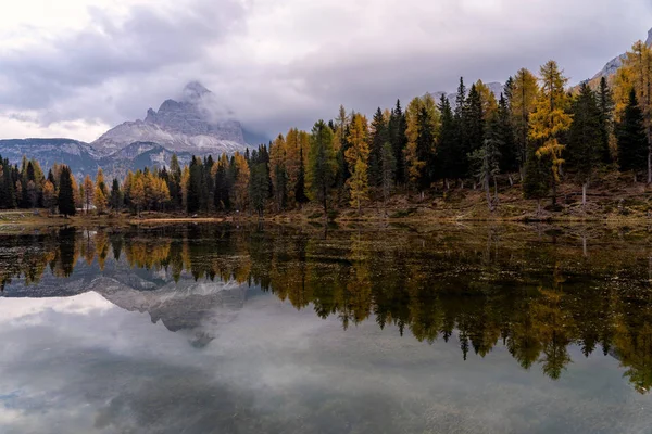 Autumn landscape of Antorno lake with famous Dolomites mountain peak of Tre Cime di Lavaredo in background in Eastern Dolomites, Italy Europe. Beautiful nature scenery and scenic travel destination in autumn colors.
