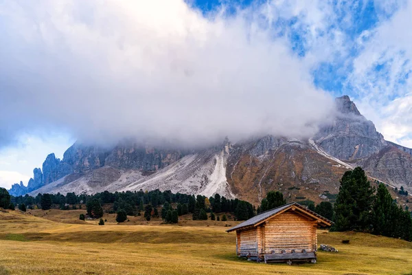Wooden rural farmer's shed (hut) in Seiser Alm meadow in the Dolomites, North Italy, Sudtirol (Trentino / Alto Adige). Scenic autumn view of a big valley in the Alps Mountains.