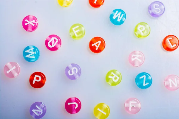 Multi color alphabet letter beads placed randomly