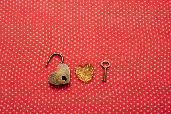 Heart shaped lock and key on red background