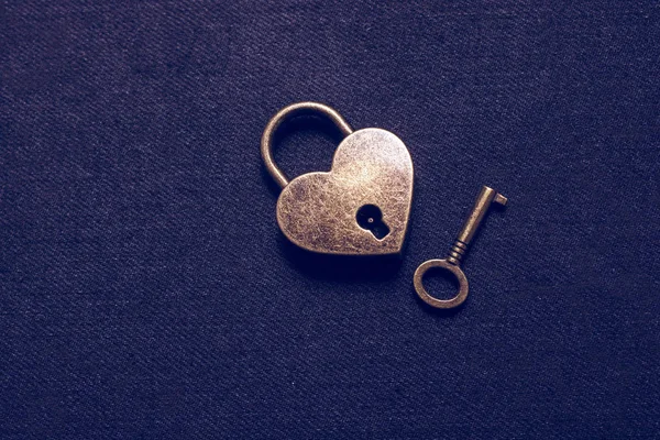 Heart shaped lock and key on abstract background