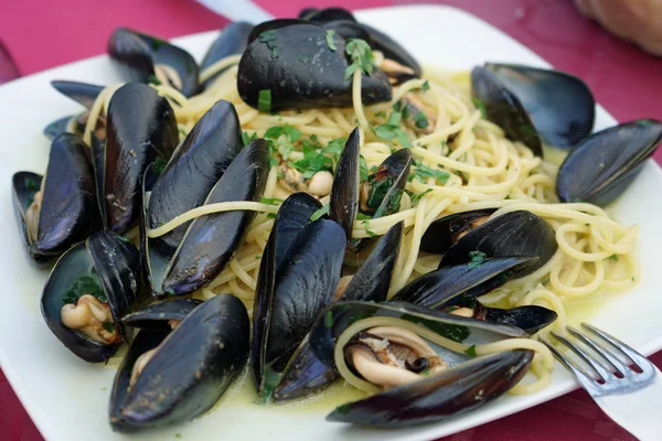 Seafood spaghetti with mussels meal in an Italian restaurant, Sicily