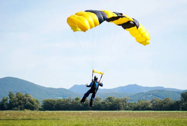 飛行機から飛び降りたパラシューティストはパラシュートを使って着陸します. — ストック写真