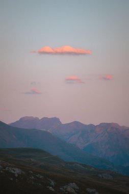 İspanya Pireneleri 'nde gün batımından sonra gökyüzünde birkaç bulutla pembe ışık