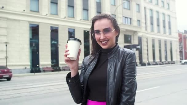 선글라스에 비즈니스 여자입니다 거리에서 컵에서 커피를 마시고 바람이 그녀의 머리를 — 비디오