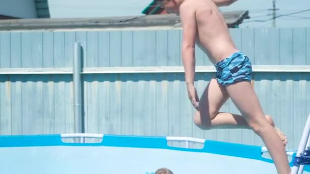 Boy Blue Swimming Trunks Cross His Neck Jumps Stairs Pool — Stock Video