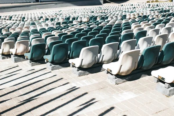 Stadium stands with aisles and white and gray plastic seats — Stock Photo, Image