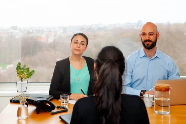 job interview in the office of a female applicant - recruiters making questions and talking with the candidate