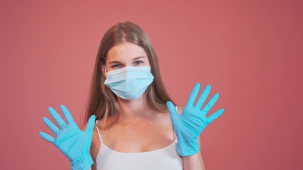 Młoda Kobieta Masce Medycznej Spogląda Kamerę Pokazuje Ręce Lateksowych Rękawiczkach — Wideo stockowe