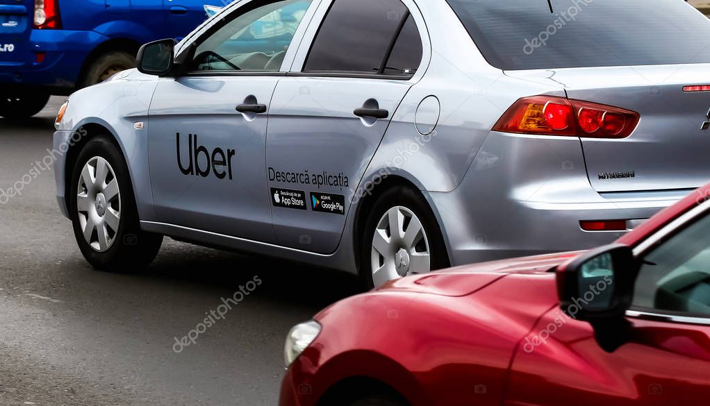 Bucharest, Romania - September 25, 2019: An Uber logo branded car is seen in traffic on a street in downtown Bucharest.