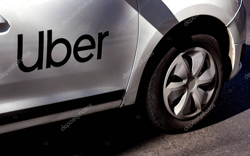 Bucharest, Romania - September 30, 2019: An Uber logo branded car is seen in traffic on a street in Bucharest.