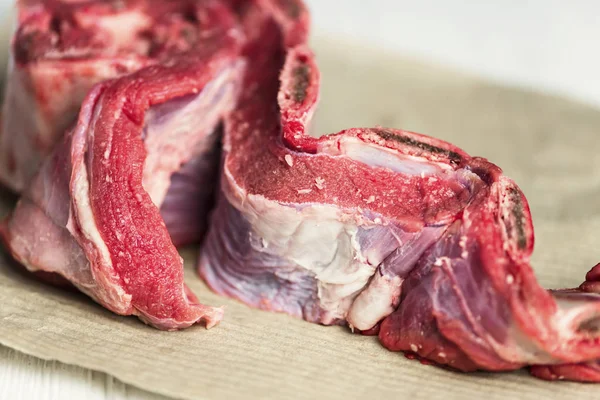 raw fresh veal ribs with meat on paper