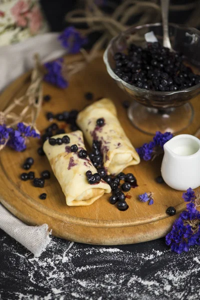 sweet pancakes with blueberry jam and berry jam in a glass vase