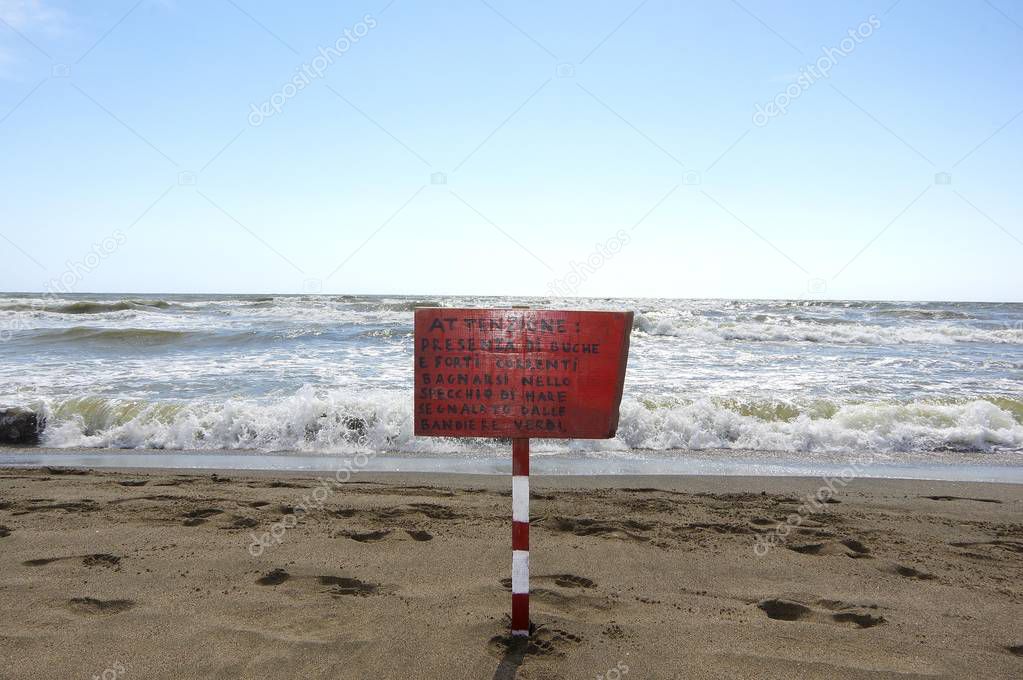 Warning sign, manuscript, on the beach of Punta Marina, Romagna sea, Italy