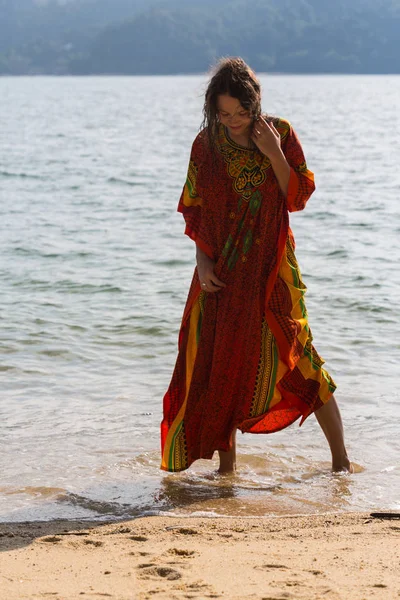 Meisje dragen floral maxi rok blootsvoets lopen op de oever van de zee, Thailand, Phuket. Boheemse kledingstijl. — Stockfoto