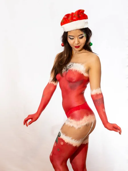 Christmas body painting on a sexy Asian girl in the form of New Years underwear. — Stock Photo, Image