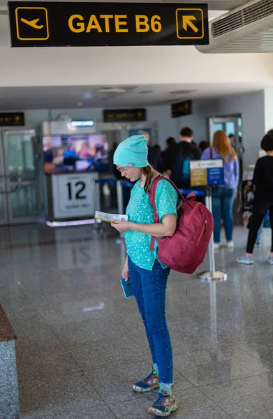 Asian nastoletnie dziewczyny za pomocą smartphone, aby sprawdzić lot na międzynarodowym lotnisku do podróży w weekendy. — Zdjęcie stockowe