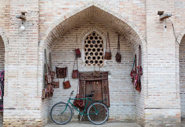 Black retro vintage bicycle with old brick wall and copy space. Retro bicycle with basket in front of the old brick wall. Retro bicycle on roadside with vintage brick wall background.