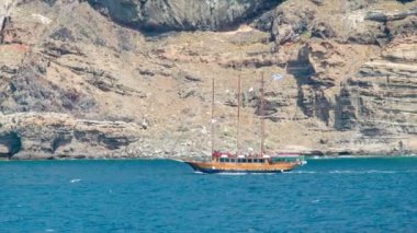 Arka Planda Dik Volkanik Dağ Kayalıkları ile Akdeniz Okyanusu'nda Santorini Yunanistan Yakın Çekim bir Gezi Turu Ahşap Yelkenli Gezi