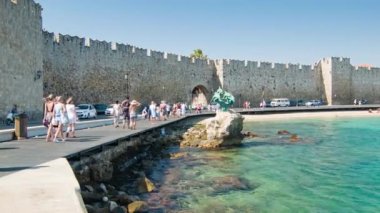 Popüler Yaz Tatili Sezonu'nda Eski Kent Tarihi Ortaçağ Kenti Duvarları yanında Rodos Yunanistan Akti Sachtouri Boyunca Yürüyüş Turistler