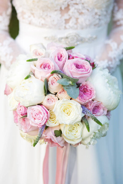 Bouquet of flowers in the hands of the bride