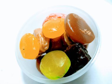 Beyaz bir kasede karışık şeker resmi var.