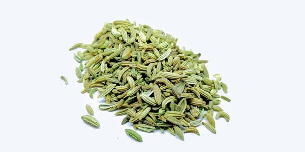 A picture of fennel seed's on a white background