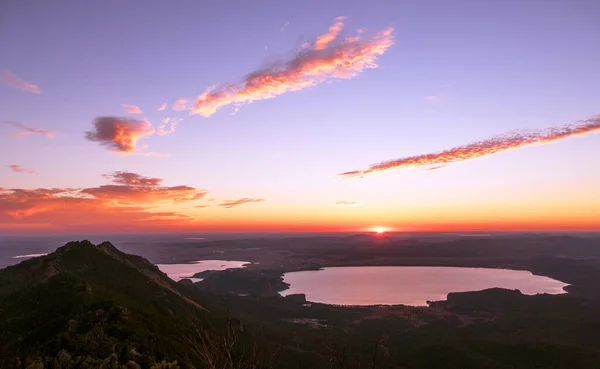 Sun rises over the horizon; majestic nature of Kazakhstan concept: Burabay lake from the highest point of Sinyuha Mountain at sunrise
