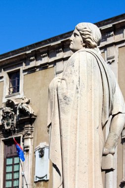 Katanya, Italya-10 Nisan 2019: arka planda bulanık Belediye Binası ile Barok Catania Katedrali üzerinde antik heykel yakalama dikey fotoğraf. Muhteşem şehir popüler turistik yerlerinden biridir