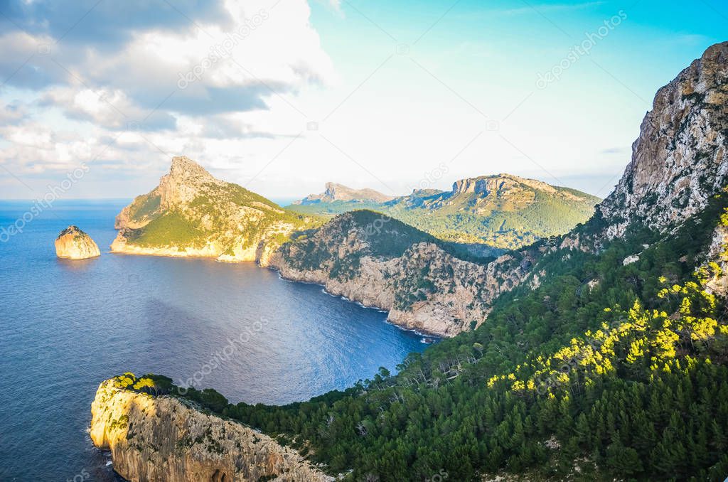 Beautiful viewpoint Mirador Es Colomer in Spanish Mallorca, Balearic Islands photographed on a sunny winter day. Cliffs and Mediterranean sea. Rock formation, green trees. Amazing view