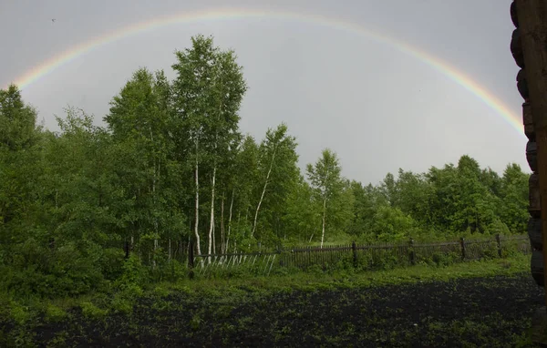 rainbow in the sky after the rain. Light refraction after rain. Miracle in the sky.