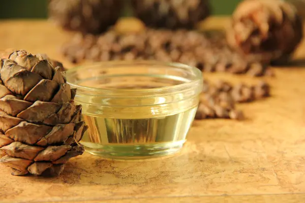 pine nuts and bottle of essential oil