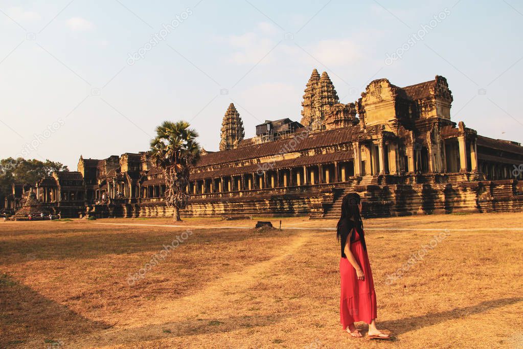 Red dressed woman in Angkor Wat temple, Siem Reap