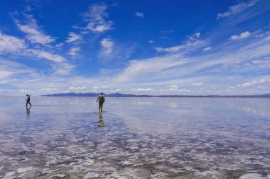 Salar de Uyuni' deki insanlar silueti ve yansımaları, Bolivya