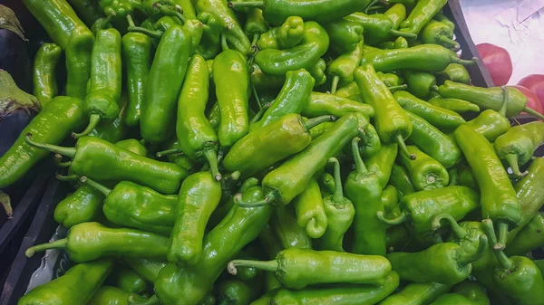 fresh green peppers at the vegetable store stand