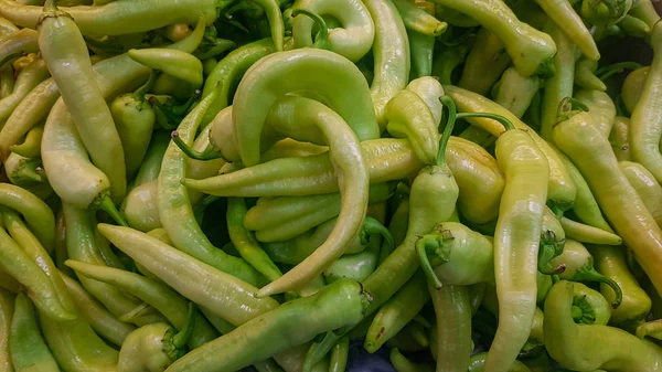 fresh green peppers at the vegetable store stand
