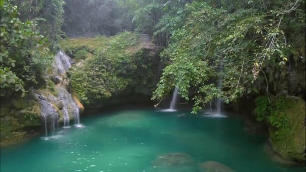 Aerial waterfall landscape with tropical green habitat on Kawasan Falls in Cebu Island in Philippines.