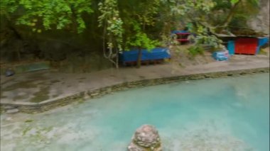 Cebu Adası, Filipinler 'deki Kawasan Şelalesi. Tropikal yağmur ormanlarında güzel bir şelale. Doğal yüzme havuzu ve dağ nehri kanyonunda bambu salı olan bir şelale..