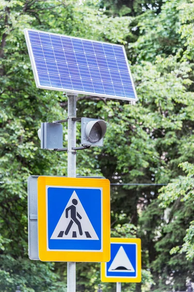 Solar cells and traffic light by the crossroad.