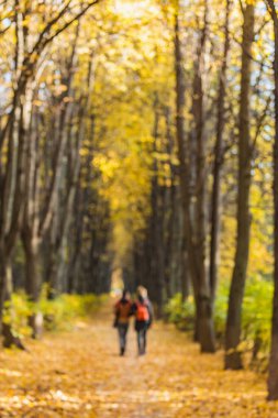 Bulanık görüntü iki kızla uzun sonbahar sokak.