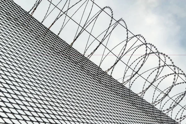 Metal fence with barbed wire in thr prison.